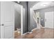 Hallway view with hardwood floors, staircase, and a half bathroom, creating a functional living space at 558 Wynfield Forest Dr, Summerville, SC 29485