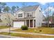 Well-maintained two-story home with stone details, a neat lawn, and a practical two-car garage at 558 Wynfield Forest Dr, Summerville, SC 29485