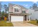Beautiful two-story home with stone accents, covered front porch, and a two-car garage at 558 Wynfield Forest Dr, Summerville, SC 29485