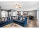 Open concept living room featuring a large blue sofa and ceiling fan at 558 Wynfield Forest Dr, Summerville, SC 29485