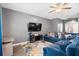 Comfortable living room with plush blue sofa, stylish decor, and a mounted television for entertainment at 558 Wynfield Forest Dr, Summerville, SC 29485