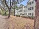 Multi-story home with well-maintained landscaping and mature trees providing shade at 60 Fenwick Hall Allee # 314, Johns Island, SC 29455