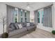 Comfortable living room features many windows, gray sofa, and neutral color palette at 60 Fenwick Hall Allee # 314, Johns Island, SC 29455