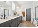 Bright bathroom with double sinks, white countertop, modern fixtures, and framed shower stall at 643 Blueway Ave, Summerville, SC 29486