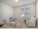 Bright bedroom with a cozy chair, playful toys, and natural light at 643 Blueway Ave, Summerville, SC 29486