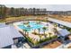 Aerial view of community pool featuring palm trees, lounge chairs, and various swim areas at 643 Blueway Ave, Summerville, SC 29486