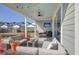 Relaxing covered patio with plush sofa seating, fire pit table, outdoor television and backyard views at 643 Blueway Ave, Summerville, SC 29486