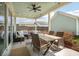 Inviting covered patio with an outdoor dining table, seating area, and a fan for comfortable outdoor living at 643 Blueway Ave, Summerville, SC 29486