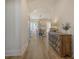 Hallway featuring modern cabinet decor, wood floors, and an open view into the dining area with natural light at 643 Blueway Ave, Summerville, SC 29486