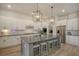 Bright kitchen featuring white cabinets, a central island with seating, and modern lighting fixtures at 643 Blueway Ave, Summerville, SC 29486