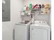 A functional laundry room with a washer, dryer, and shelving for organized storage of supplies at 643 Blueway Ave, Summerville, SC 29486