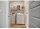 Convenient laundry room with white washer and dryer set and practical shelving at 643 Blueway Ave, Summerville, SC 29486