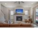 Cozy living room with a fireplace, large leather sectional, and ample natural light at 643 Blueway Ave, Summerville, SC 29486