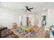 Spacious living room featuring wood floors, modern ceiling fan, and play area at 643 Blueway Ave, Summerville, SC 29486