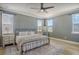 Calming main bedroom featuring a plush bed, neutral tones, and plenty of natural light from the windows at 643 Blueway Ave, Summerville, SC 29486