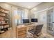 Bright home office featuring modern desk, storage shelves, and plenty of natural light from a large window at 643 Blueway Ave, Summerville, SC 29486