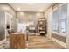 Stylish home office with a large window, neutral wall color, modern desk setup, and shelving for storage at 643 Blueway Ave, Summerville, SC 29486