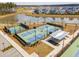 Aerial view of community pickleball courts, featuring multiple well-lit courts and covered seating area at 643 Blueway Ave, Summerville, SC 29486