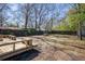 Large backyard with mature trees, and wood deck with built-in seating at 716 W 3Rd N St, Summerville, SC 29483