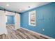 Bright bedroom featuring stylish flooring, windows, and modern barn door to another room at 716 W 3Rd N St, Summerville, SC 29483