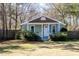 Inviting home exterior with a quaint porch, blue shutters, and lush greenery around the front at 716 W 3Rd N St, Summerville, SC 29483
