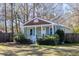 Charming cottage-style home with a cozy front porch, blue shutters, and a well-maintained yard at 716 W 3Rd N St, Summerville, SC 29483