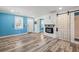 Bright living room with electric fireplace, stylish flooring, and modern sliding barn door at 716 W 3Rd N St, Summerville, SC 29483