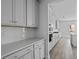Stylish kitchen with white cabinets, quartz countertops, and stainless steel appliances at 747 Maynard Ln, Summerville, SC 29486