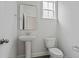 Neutral powder room featuring a pedestal sink, mirror, and tiled floors at 747 Maynard Ln, Summerville, SC 29486