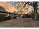 Expansive backyard featuring a large shade tree, storage buildings, and wood fencing, with a brick house in the background at 7753 Linsley Dr, North Charleston, SC 29418