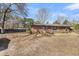 Backyard view featuring a brick house, wooden fence, shade tree and storage buildings at 7753 Linsley Dr, North Charleston, SC 29418
