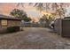 A wide shot of a backyard showing a brick house, wooden fence and multiple storage buildings at 7753 Linsley Dr, North Charleston, SC 29418