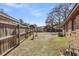 Backyard with wooden fence, lawn, brick house and multiple storage buildings at 7753 Linsley Dr, North Charleston, SC 29418
