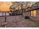 Backyard featuring a brick house, wooden fence, storage buildings, and lawn at 7753 Linsley Dr, North Charleston, SC 29418