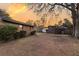 Spacious backyard featuring a large shade tree, storage buildings, and wood fencing, with a brick house in the background at 7753 Linsley Dr, North Charleston, SC 29418