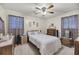 Comfortable bedroom with a ceiling fan, patterned curtains, and bedside tables at 7753 Linsley Dr, North Charleston, SC 29418