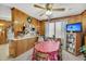 Cozy dining area with wood paneling, a large table, and views of the kitchen at 7753 Linsley Dr, North Charleston, SC 29418