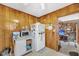 Cozy kitchenette featuring wood-paneled walls, a microwave, and a refrigerator at 7753 Linsley Dr, North Charleston, SC 29418