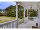 Charming front porch with white railings, views of the lawn, and inviting ambiance at 7805 Seafield Rd, Yonges Island, SC 29449