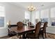 Traditional dining room featuring a wooden table, upholstered chairs, chandelier, and sun-filled windows at 804 S Pointe Blvd, Summerville, SC 29483