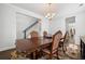 Traditional dining room showcases a wooden table, upholstered chairs, chandelier and access to the stairway at 804 S Pointe Blvd, Summerville, SC 29483