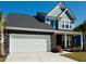 Charming two-story home featuring a two-car garage, stone accents, and a manicured lawn at 804 S Pointe Blvd, Summerville, SC 29483