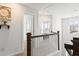 Upstairs hallway with wood railing, white walls, carpet and lots of natural light at 804 S Pointe Blvd, Summerville, SC 29483