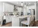 Bright kitchen features white cabinetry, stainless steel appliances, pendant lighting, and a breakfast bar at 804 S Pointe Blvd, Summerville, SC 29483