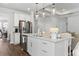 This modern kitchen has stainless steel appliances, a large island, and seamless access to the living area at 804 S Pointe Blvd, Summerville, SC 29483