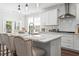 Modern kitchen features white cabinets, a spacious island with seating, and stainless steel appliances at 804 S Pointe Blvd, Summerville, SC 29483