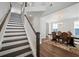 An open staircase leads to a dining room featuring a wooden table, upholstered chairs, and elegant chandelier at 804 S Pointe Blvd, Summerville, SC 29483