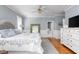 Spacious bedroom featuring soft blue tones, hardwood floors, and large windows at 8608 Wild Bird Ct, North Charleston, SC 29420