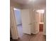 Bedroom with hardwood flooring and two closet doors, leading to a bathroom at 9044 Greenbriar Dr, Summerville, SC 29485