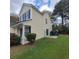 Charming two-story home with side-entry garage, manicured lawn, and mature landscaping at 9044 Greenbriar Dr, Summerville, SC 29485